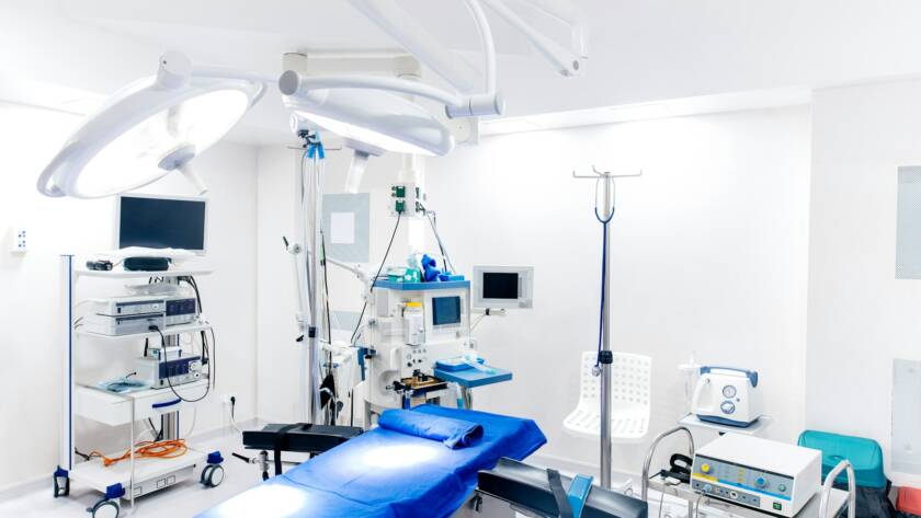 Medical devices and industrial lamps in surgery room of modern hospital.