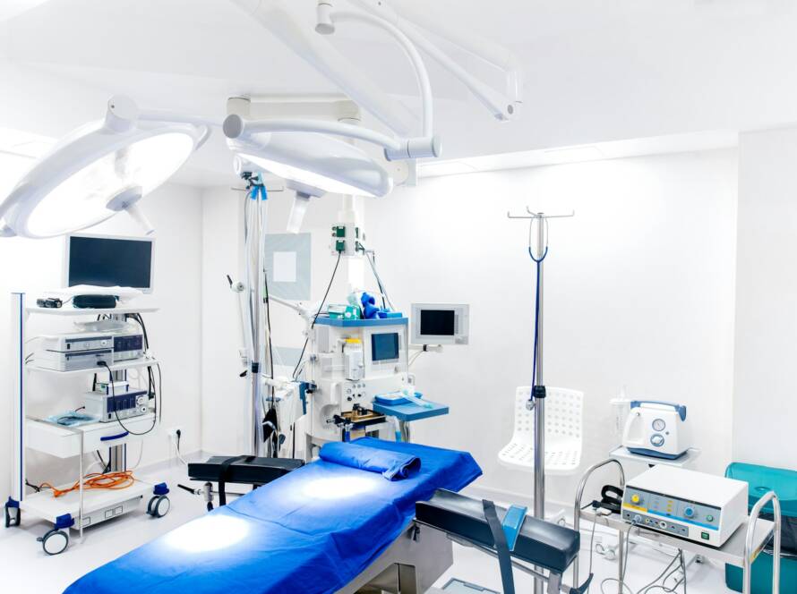 Medical devices and industrial lamps in surgery room of modern hospital.